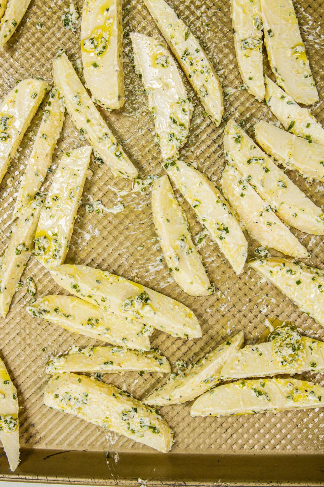 Sour cream and chive fries on baking sheet