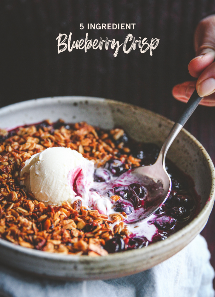 Blueberry crispy with ice cream in a shallow bowl