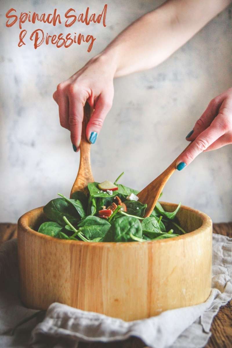 Mixing a salad with wooden utensils