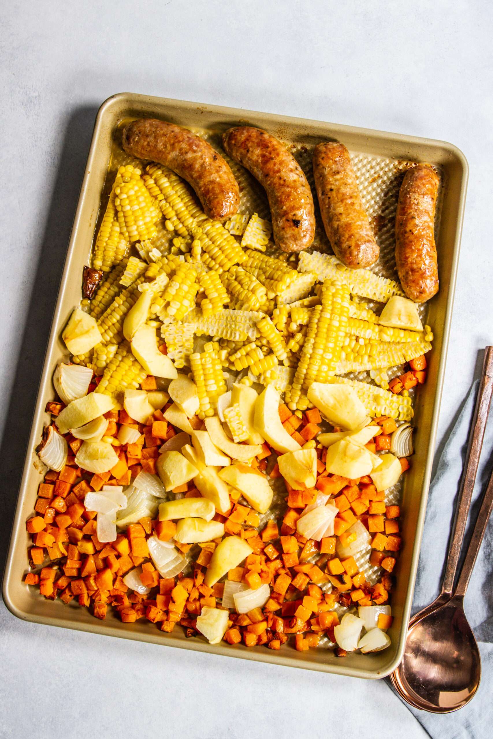 Squash, apple, corn, sausage on sheet pan