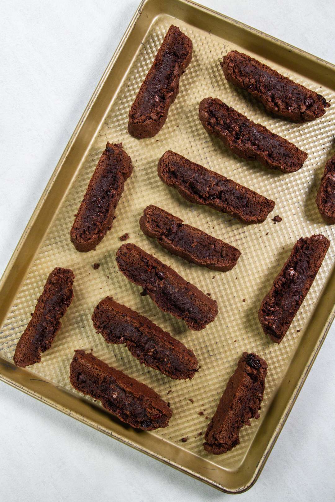 Chocolate cherry biscotti on a sheet pan