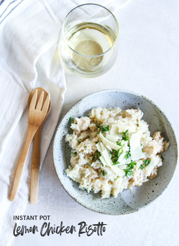 Risotto in bowl with glass of white wine